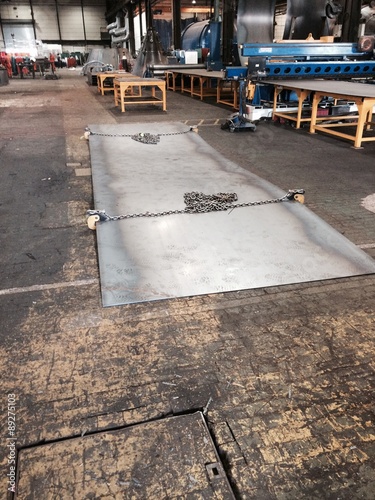 sheet of steel with heavey lifting chains and clamps photo