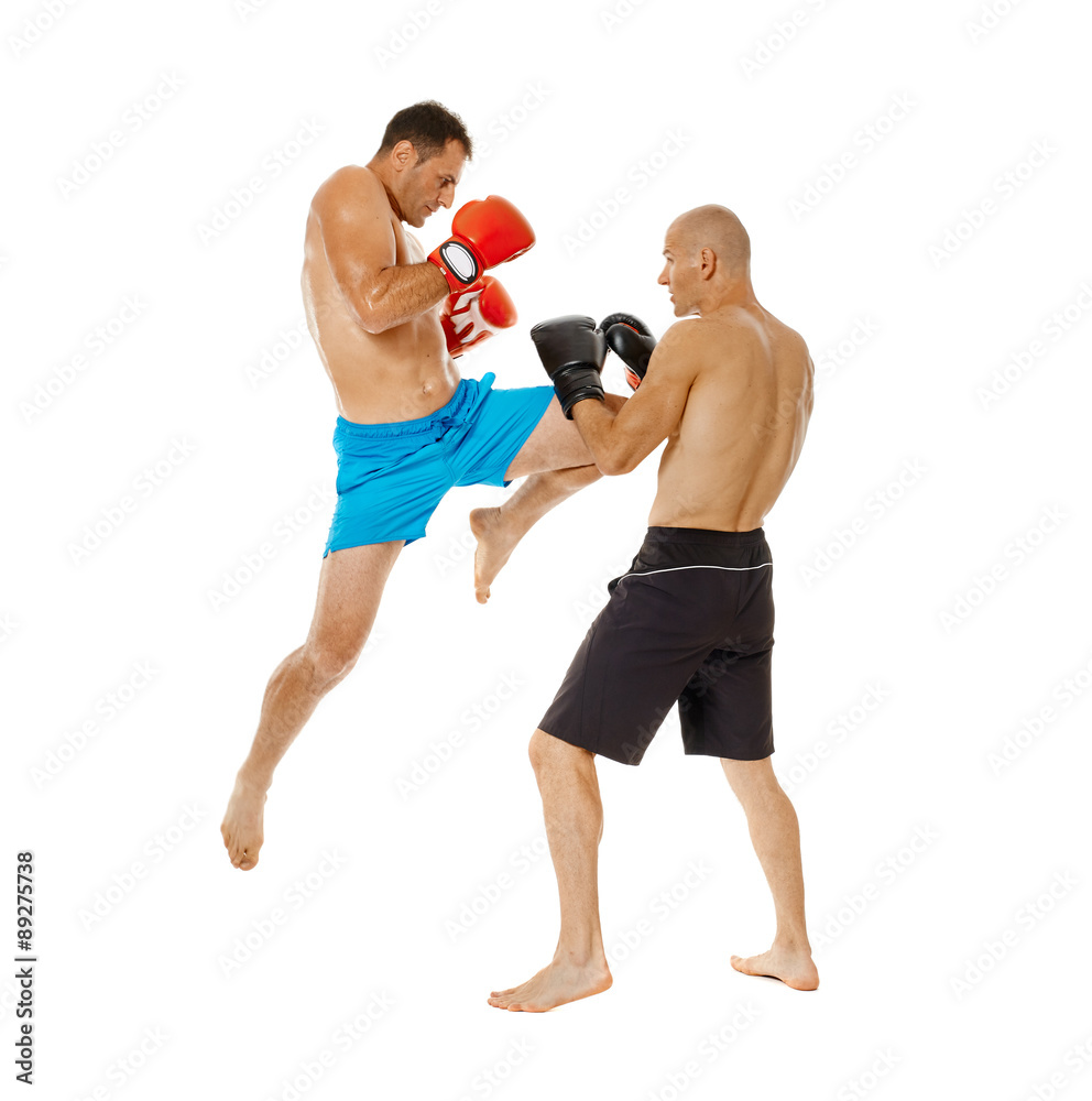 Kickboxers sparring on white