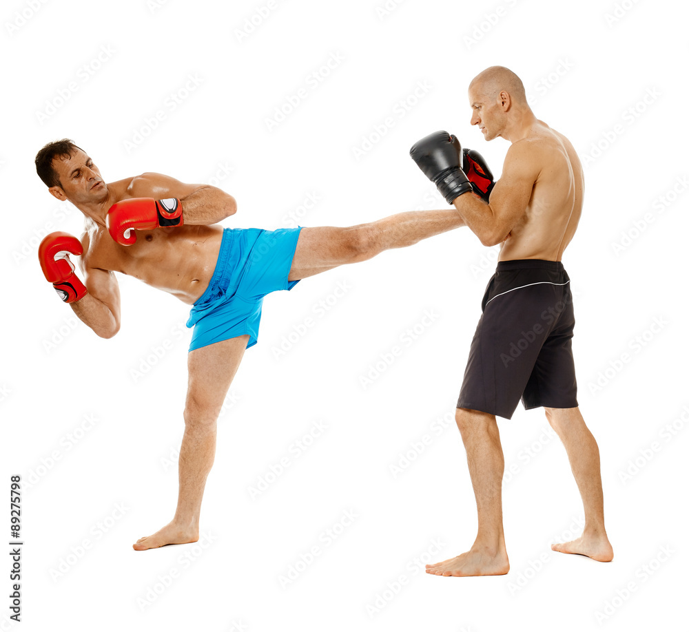 Kickboxers sparring on white