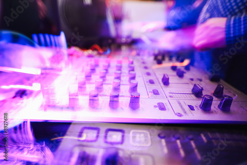 Club DJ playing mixing music on vinyl turntable