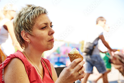 Pretty blond woman with ice cream