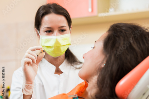 Photography Dentist with patient's tooth