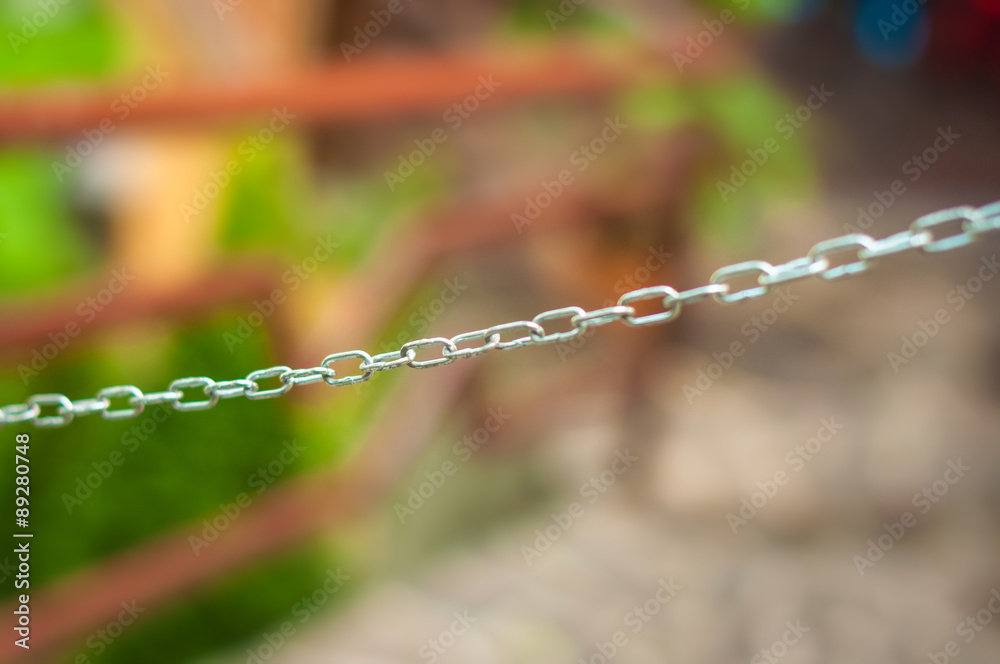 Chain on blurred background - can represent the notion of obstacle, denial of access, but also teamwork, strength etc. Chain on blurred background - can represent the notion of obstacle, denial of access, but also teamwork, strength etc.