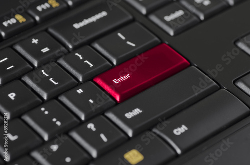 Red enter key on black computer keyboard