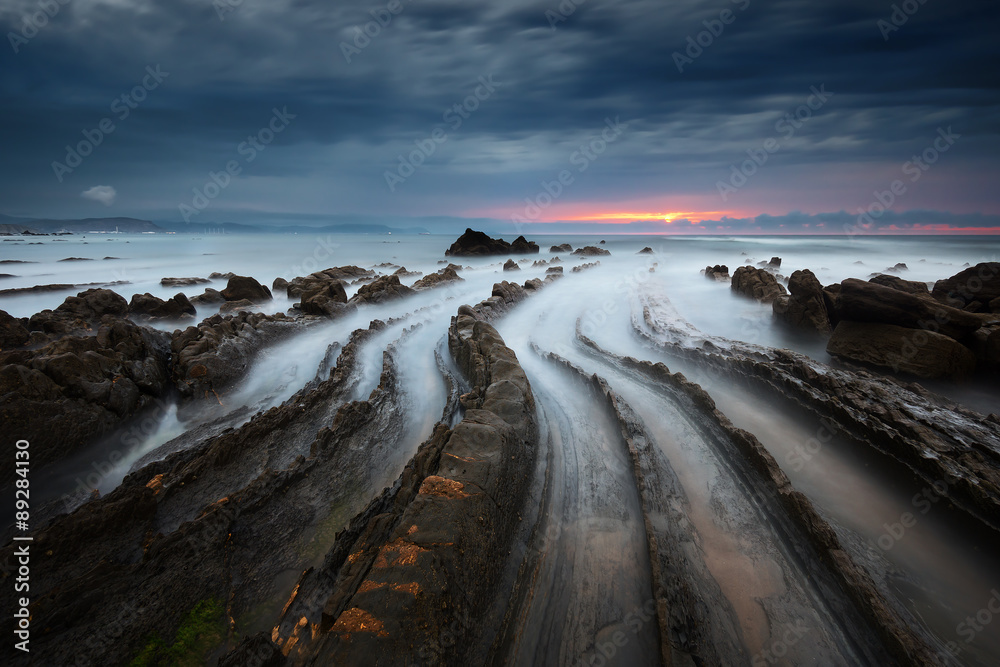 flysch rocks in barrika beach at sunset