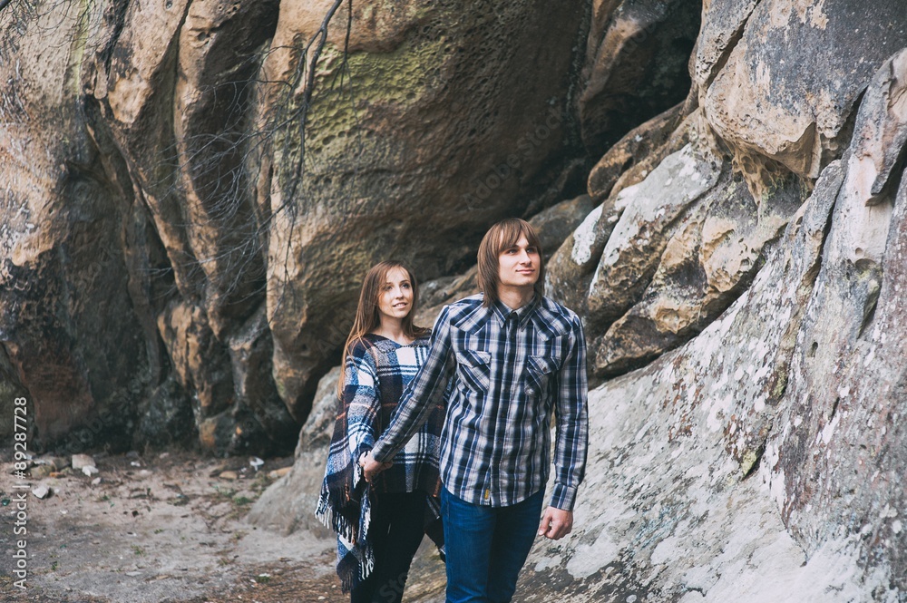 couple in love, walk on the rocks Dovbush Carpathian Mountains