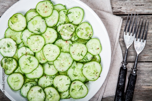 green salad with fresh organic cucumbers and dill with olive oil closeup