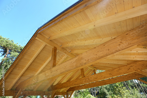 wooden roof construction of outdoor carport photo
