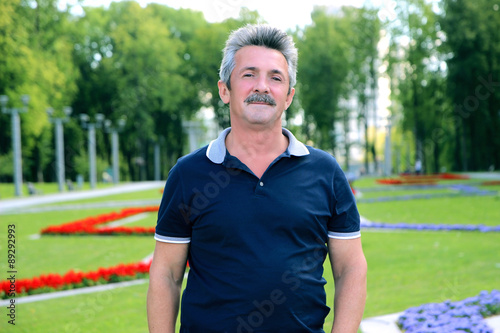 Portrait of handsome mature man. Handsome trendy mature man. Middle age man in an outdoor setting. The man with the mustache