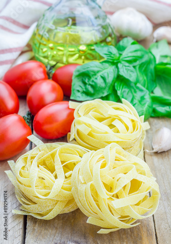 Raw tagliatelle pasta on the wooden table