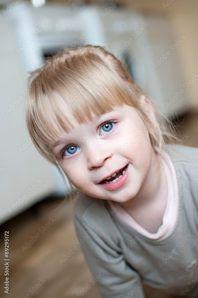 Baby girl 3-4 years lies on the floor and smiles Baby girl 3-4 years lies on the floor and smiles