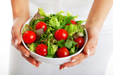 Salad bowl in woman hands