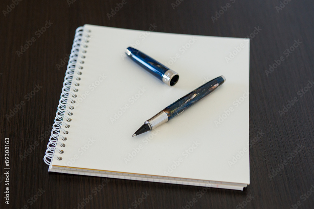 Blank notepad on office wooden table Blank notepad on office wooden table