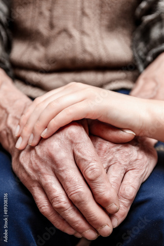 Hands of the old man and a young woman.. toning