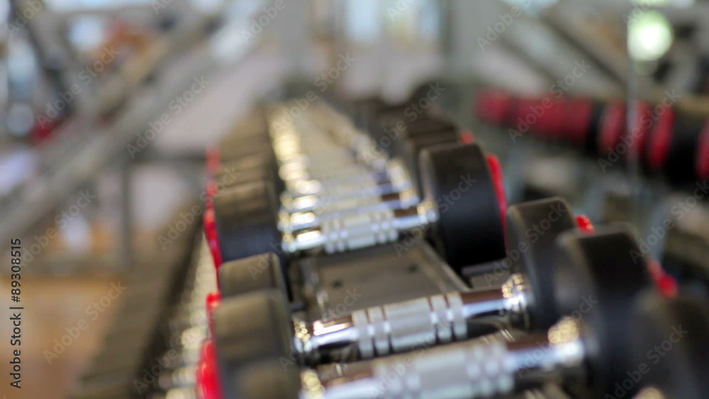 Hand holding dumbbell.Close up.Muscular arm in the gym. Training Hand holding dumbbell.Close up.Muscular arm in the gym. Training