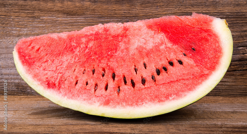 Slices of watermelon on old wooden background Slices of watermelon on old wooden background