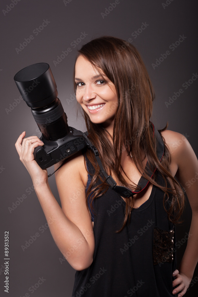 Professional female photographer holding camera Professional female photographer holding camera