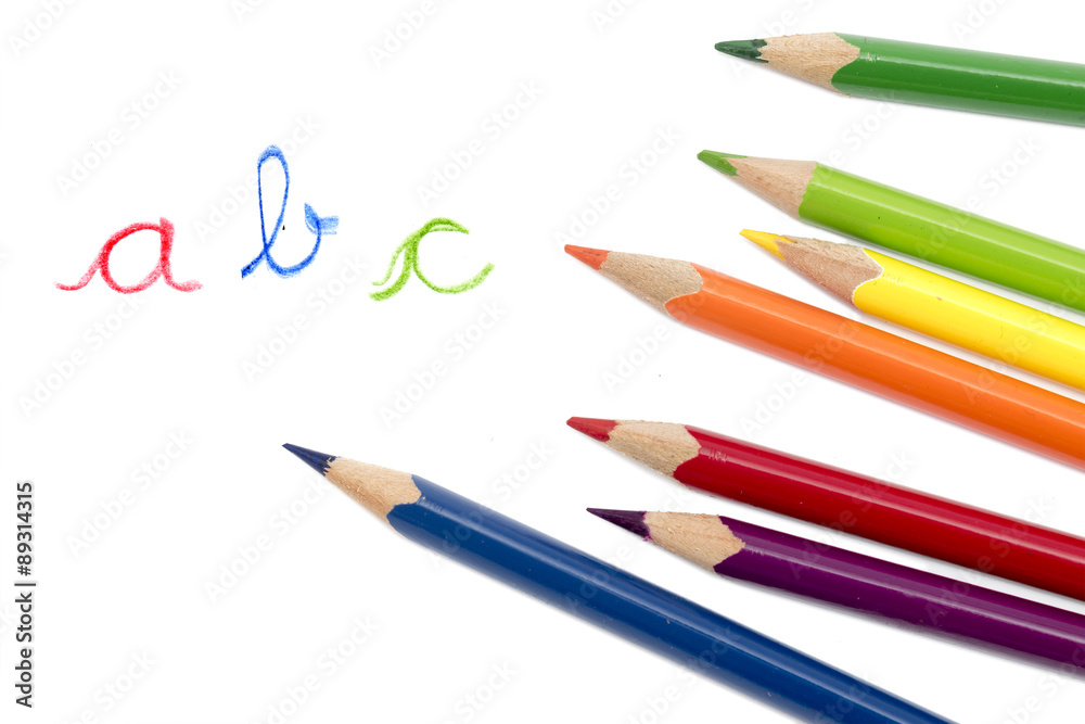 colored pencils and handwritten letters ABC isolated on white