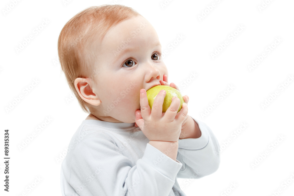 Baby eating green apple. Studio Half Length Portrait , isolated on a white background Baby eating green apple. Studio Half Length Portrait , isolated on a white background
