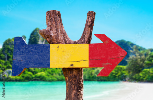 Romania Flag wooden sign with beach background photo