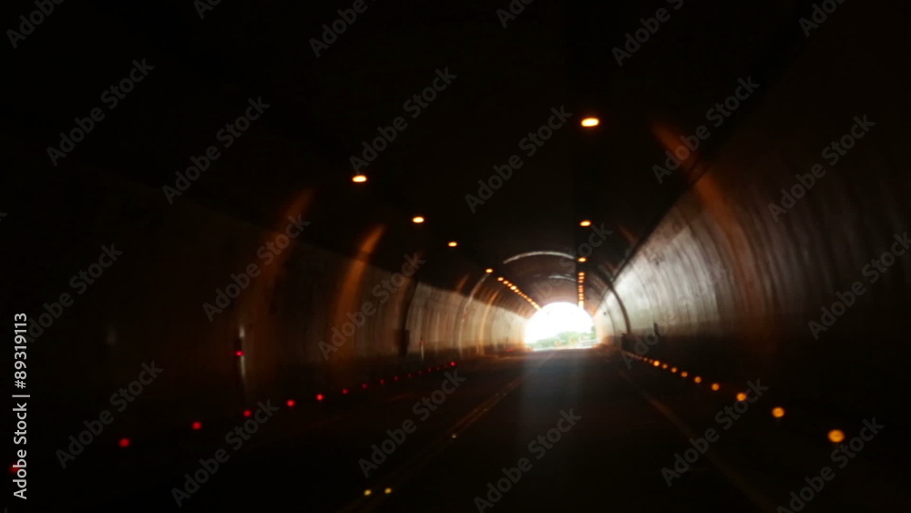 Driving through tunnel with light of exit at end
Driving through tunnel with light of exit at end