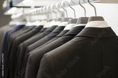 Fotografie Men suits hanging in a clothing store.