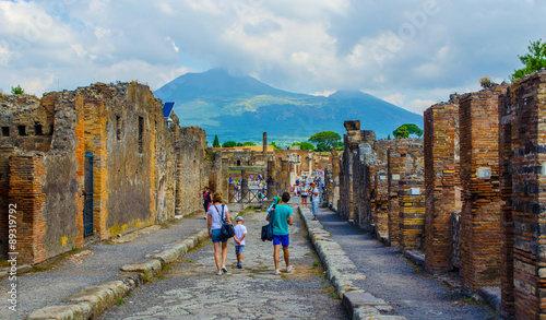 Tela people are walking through ruins of the historical city of pompeii