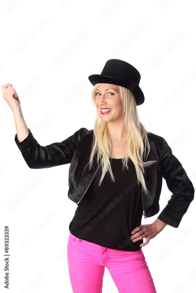 Attractive blonde woman in her 20s wearing a black jacket, pink pants and a top hat. White background. Attractive blonde woman in her 20s wearing a black jacket, pink pants and a top hat. White background.