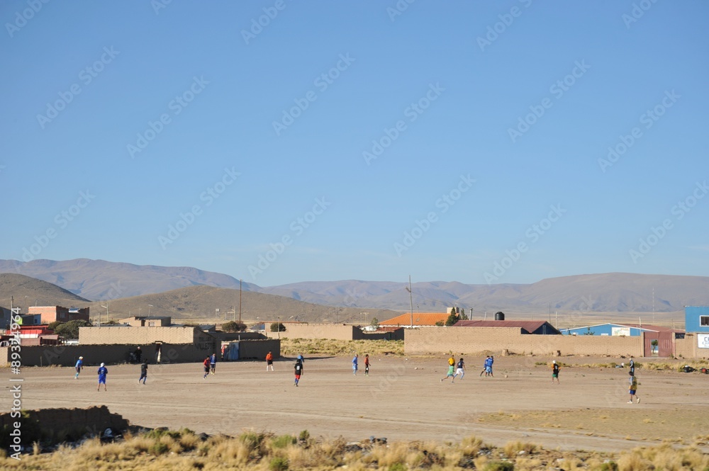 Obraz premium Residents of a Bolivian mountain village play football.