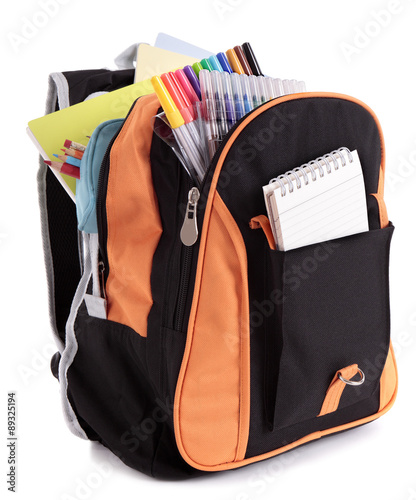 School satchel bag backpack with various books pencils crayons and study equipment isolated on white background photo photo