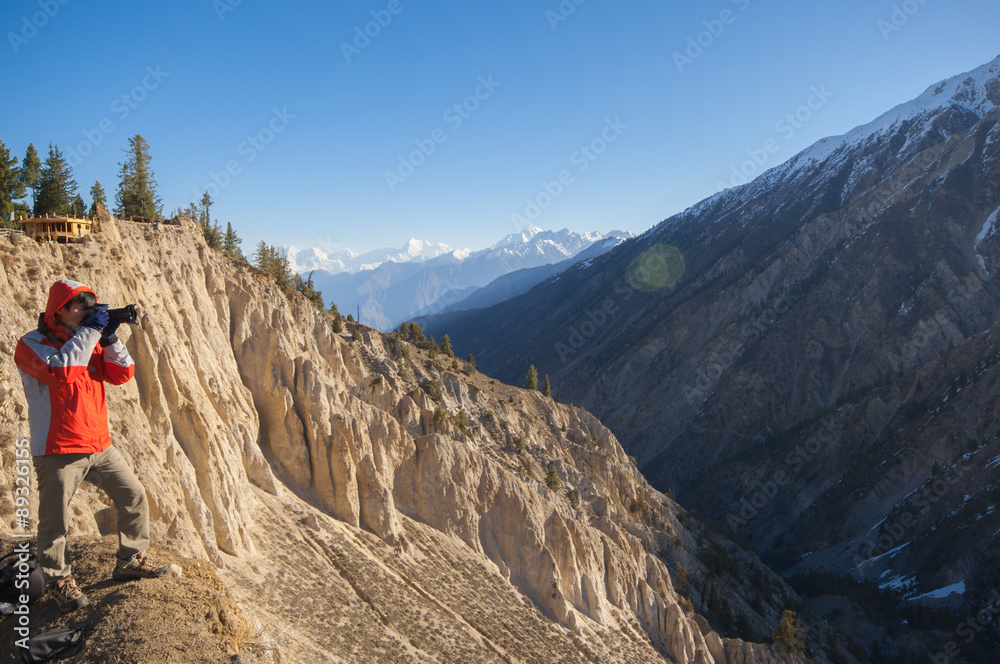 Tourist with a backpack and mountain panorama