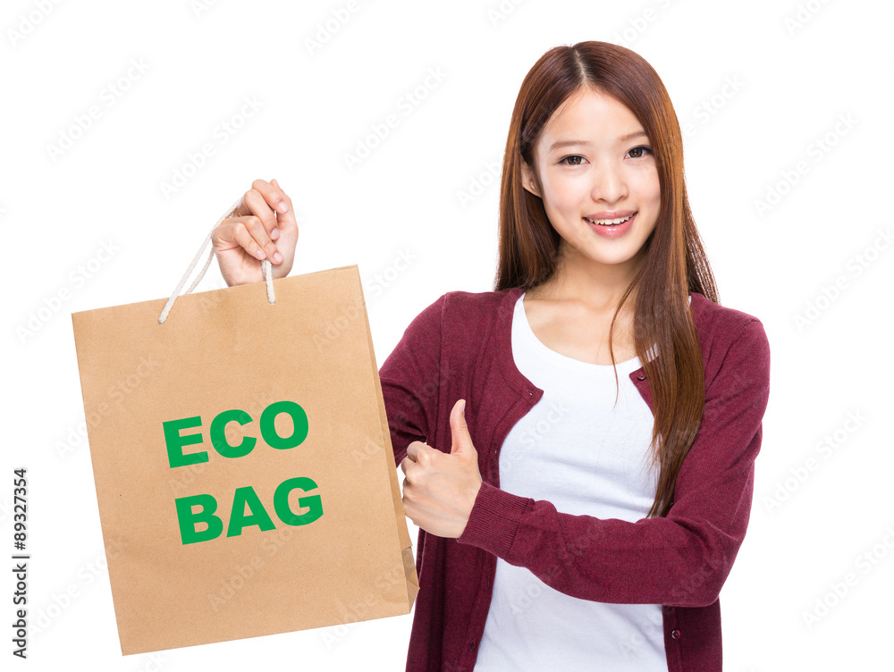 Young Woman hold with shopping bag and thumb up for showing eco Young Woman hold with shopping bag and thumb up for showing eco