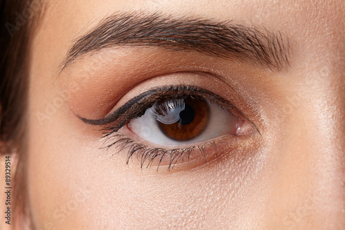 Female eye close-up. Arrow makeup. Macro. 