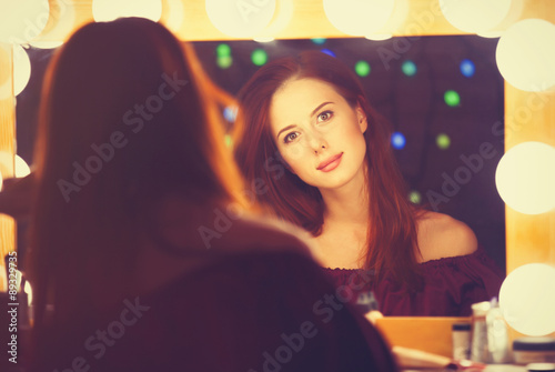 Portrait of a beautiful woman as applying makeup