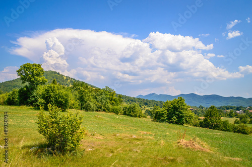 A mountain scenery of a hill on Velebit and a pillar of clouds c photo