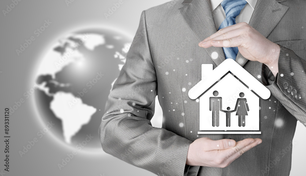 businessman protecting family in home with hands businessman protecting family in home with hands