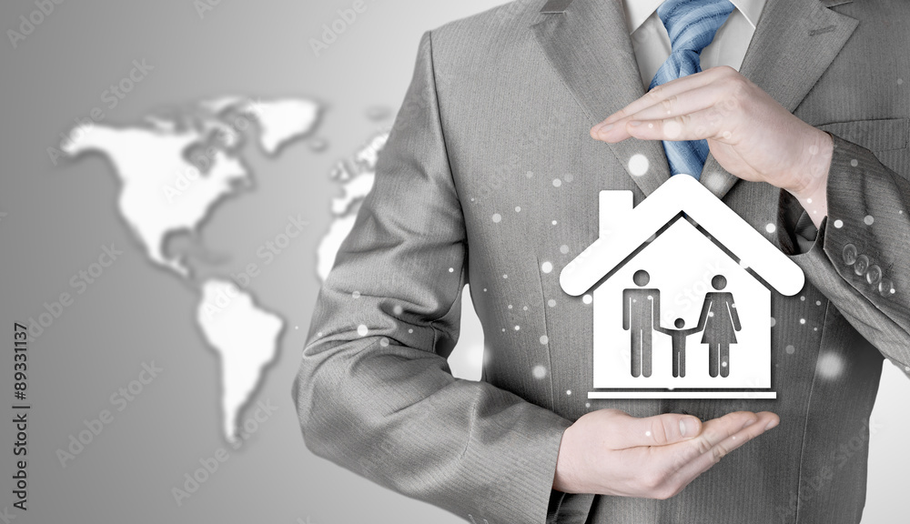 businessman protecting family in home with hands businessman protecting family in home with hands