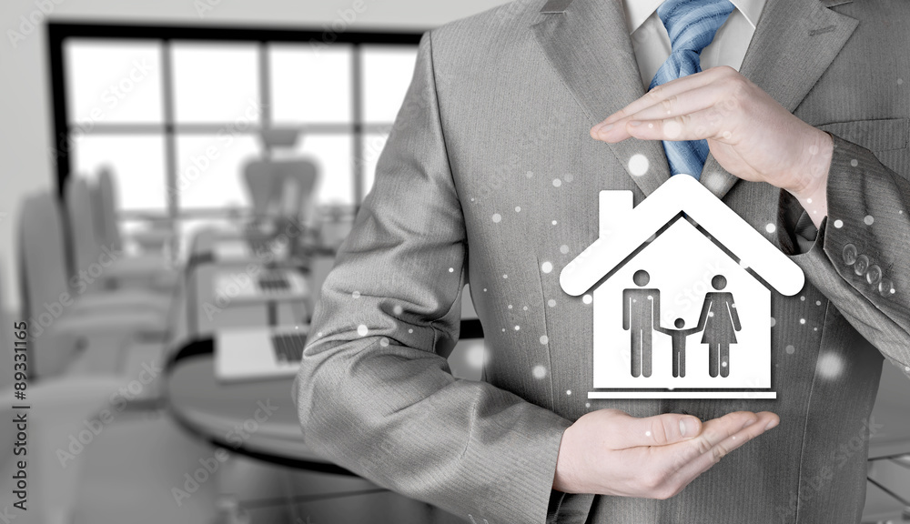 businessman protecting family in home with hands businessman protecting family in home with hands