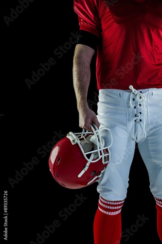 American football player holding his helmet © WavebreakmediaMicro