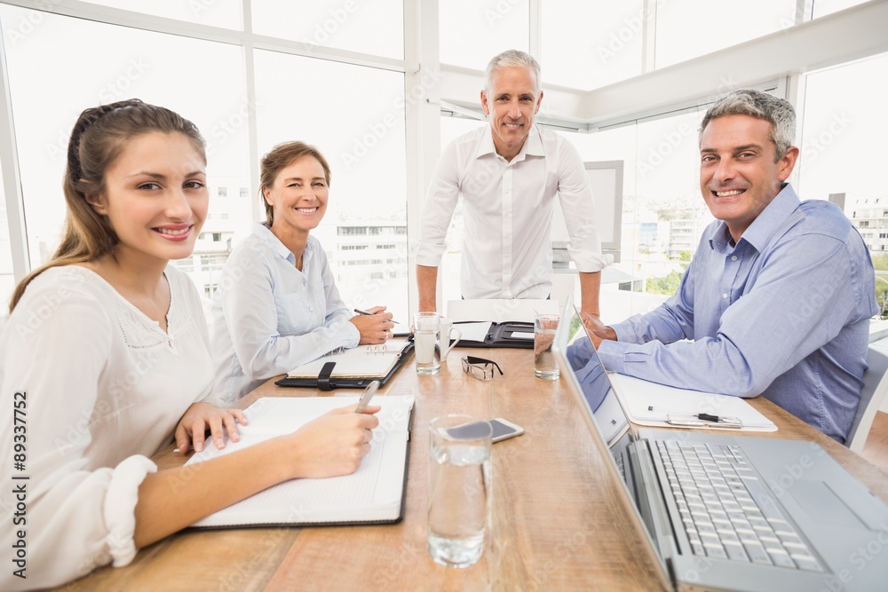 Smiling business people during a presentation Smiling business people during a presentation