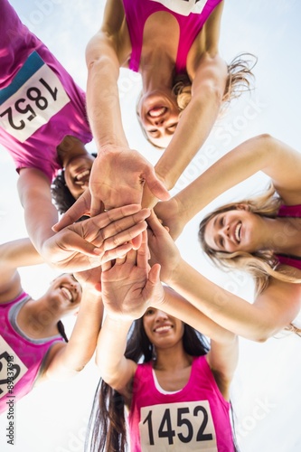 Fototapeta Naklejka Na Ścianę i Meble -  Five smiling runners supporting breast cancer marathon