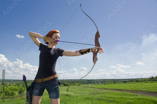 Archery woman bends bow archer target narrow