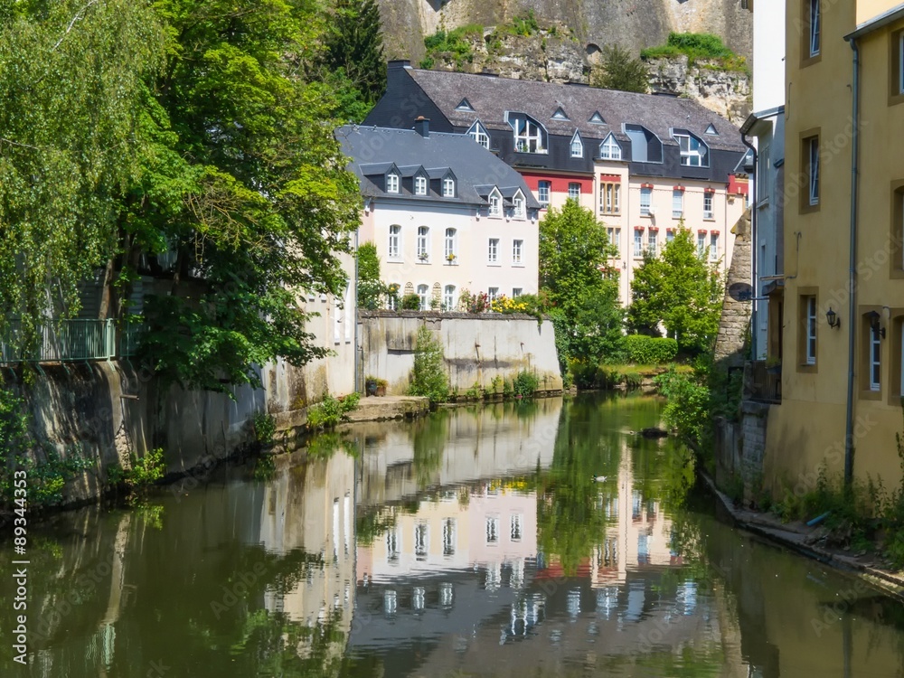 Old houses and reflections in the Alzette river. Grund district, Luxembourg