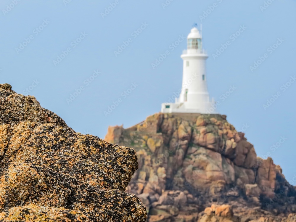 Lighthouse on the rocky coast of Jersey Island