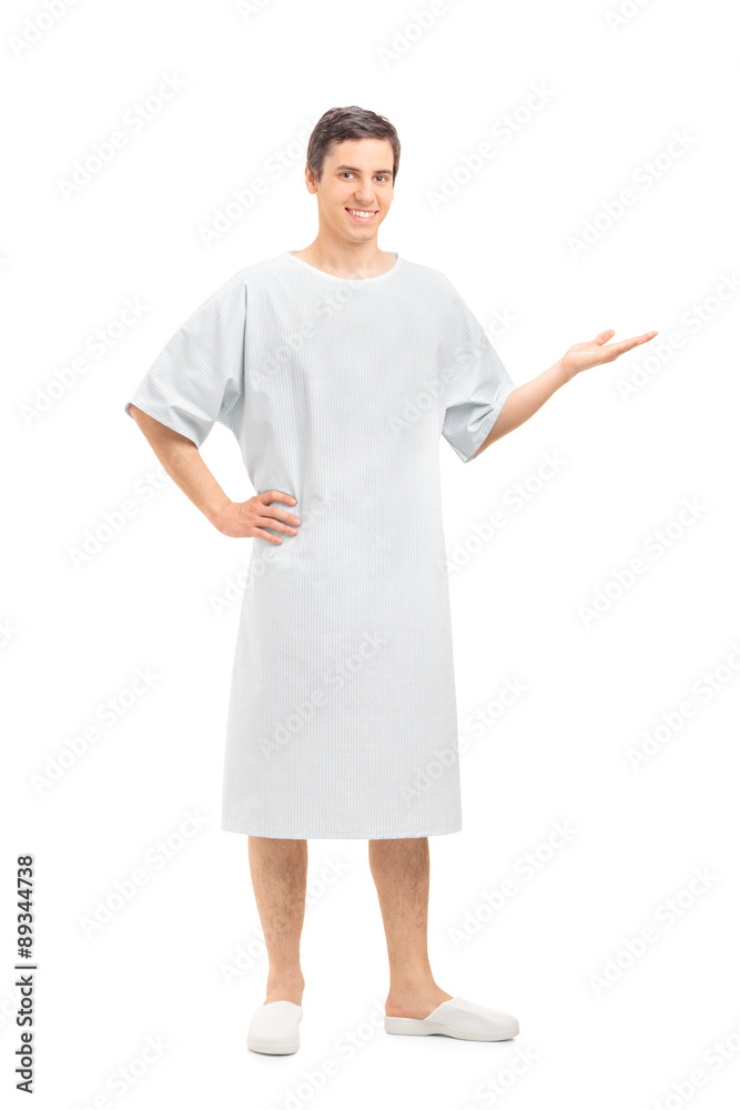 Young patient in a hospital gown gesturing with hand