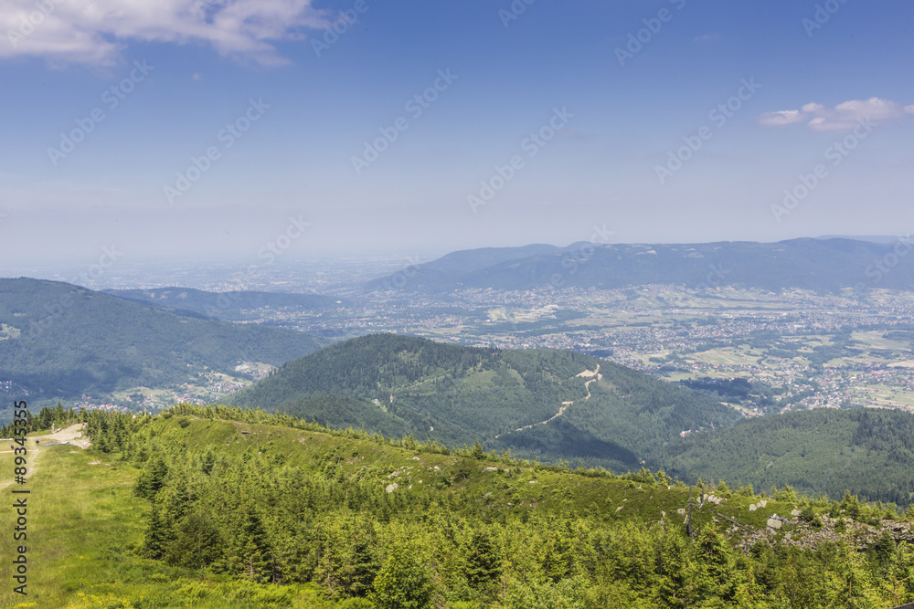 Mountain landscape from Skrzyczne. Hillside covered with pine tr
