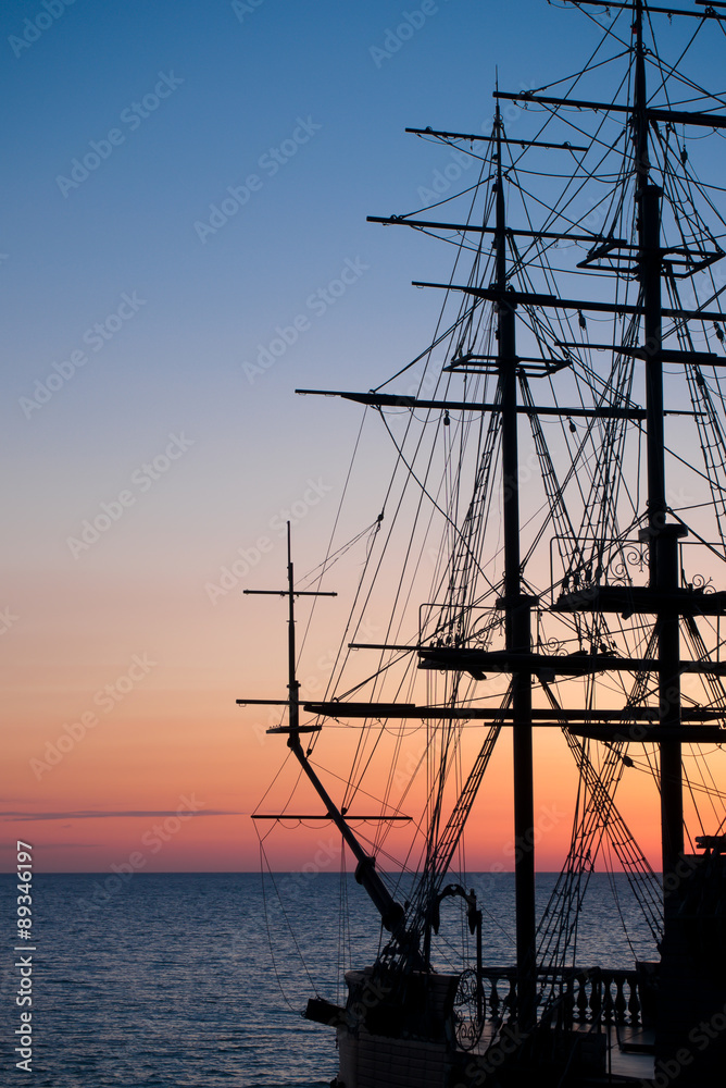 Silhouette of the old ship at sunset