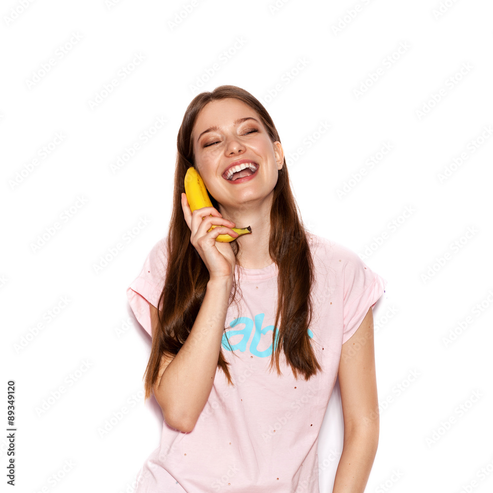 young funny woman holding banana as telephone young funny woman holding banana as telephone