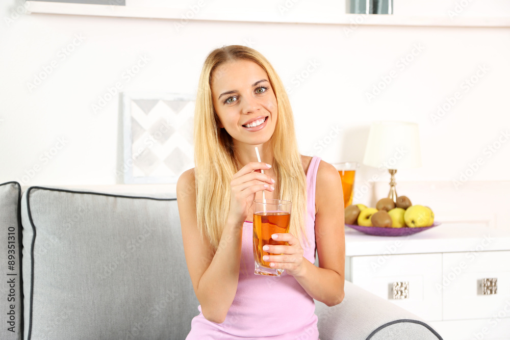 Young beautiful woman drinking fresh apple juice