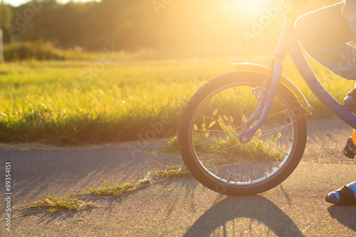 child riding bike at sunset